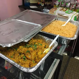 two trays of food on a counter