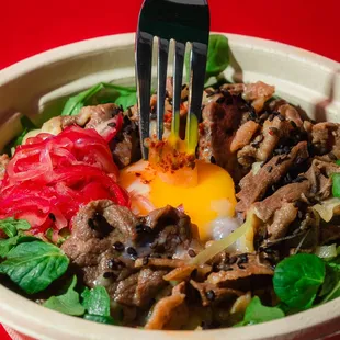 a fork in a bowl of food