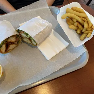 Buffalo chicken wrap with a side of fries.