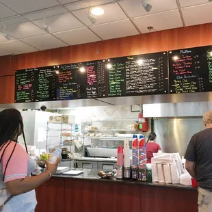 Menu listed on a board above counter.