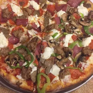 Meat lovers large pizza with ricotta cheese, mushrooms, and green peppers added. Really really good!