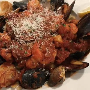 a plate of pasta with musselling and clams