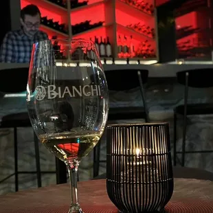 a glass of wine and a candle