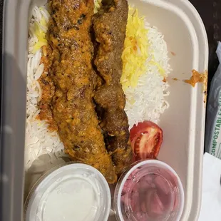 a tray of food with rice and meat