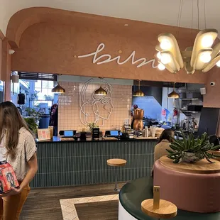 a woman standing in front of a counter