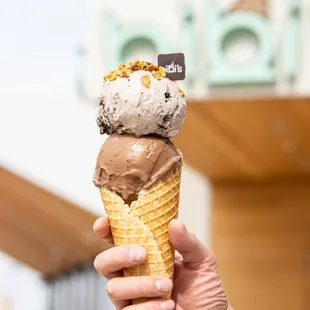 a hand holding an ice cream cone