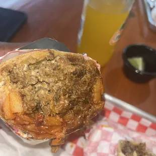 Steak and Potato burrito with green sauce and sour cream.  Looks simple but the flavor is literally TOP TIER!