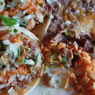 This is some of the delicious food that they served us today. These are street tacos. With rice and beans to the side.