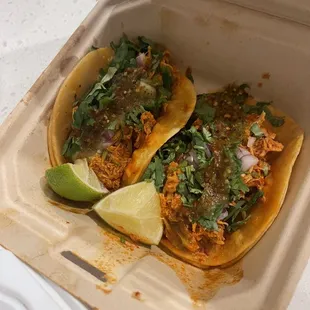 two tacos in a styrofoam container