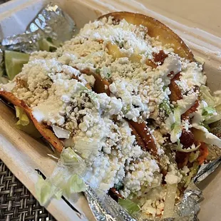 Crispy chicken taco and crispy asada taco