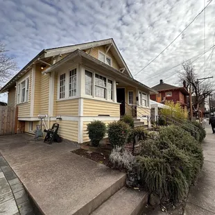 a yellow house with steps leading up to it