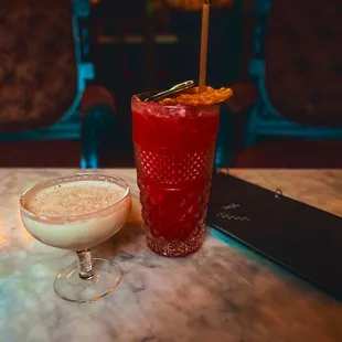 a cocktail and a cocktail glass on a table