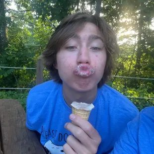 a boy eating an ice cream cone