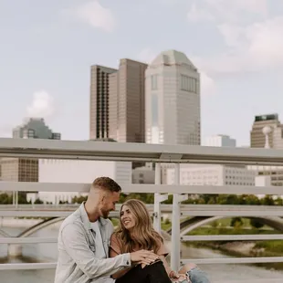 engagement photos with columbus downtown skyline on main street bridge