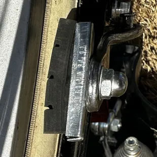 The "mechanic" tried to push the rubber brake pad back in with his fingers but didn't get it fully re-seated.