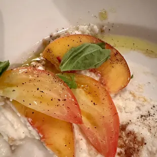 Whipped mozzarella covered by fresh, sliced peaches, and heirloom tomatoes, basil, and delicious olive oil.