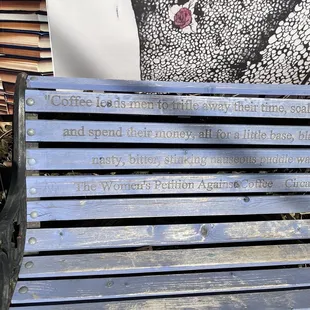 a wooden bench with a plaque on it