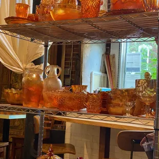 a shelf of glassware