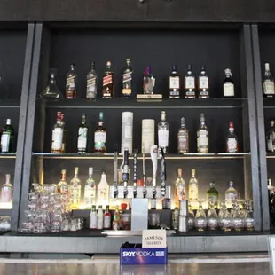 a bar with many bottles of alcohol