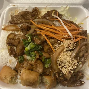 Vermicelli beef with egg rolls and greens