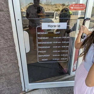 a little girl standing in front of the door