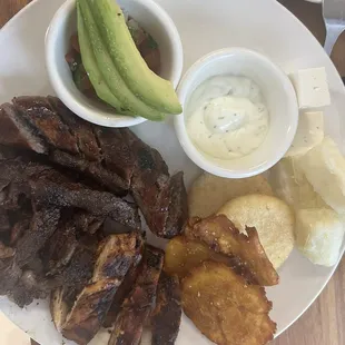 tray with beef, chicken, tostones, cheese, arepas and avocado
