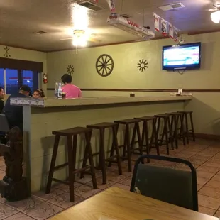 Narrow island bar seating in the middle of the dining area