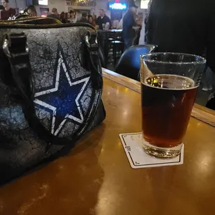 a pint of beer on a bar