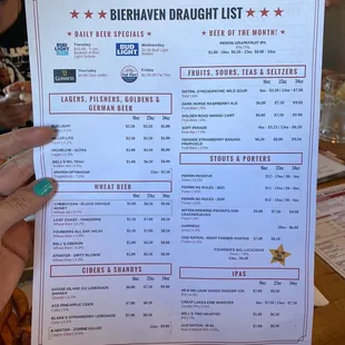 a person holding up a menu