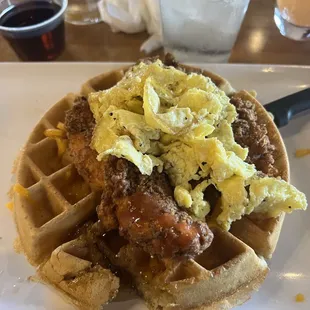 Chicken and waffles with scrambled eggs but it comes with an over easy egg