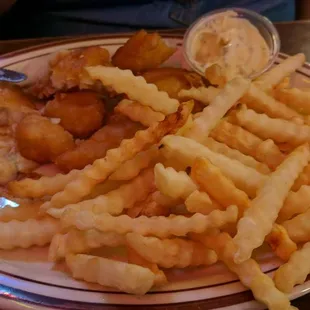 a plate of french fries and fried fish