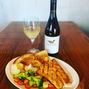 a plate of food and a glass of wine