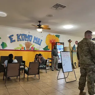 a man in a military uniform standing in a restaurant