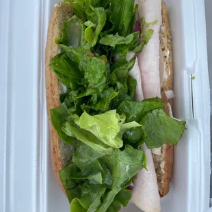 a sandwich in a styrofoam container