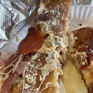 Damn delicious calzone with mushrooms, sausage, garlic, pepperonis ham