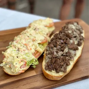 two sandwiches on a cutting board