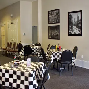 tables and chairs with checkered tablecloths