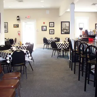 tables and chairs with black and white checkered tablecloths