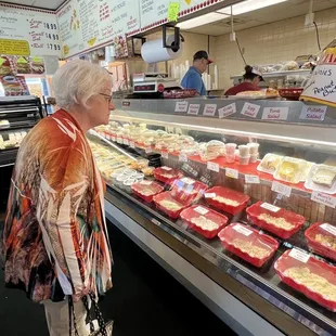 a woman looking at meat