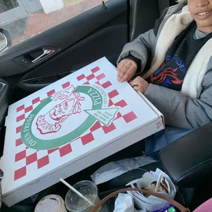 a young boy sitting in the back seat of a car