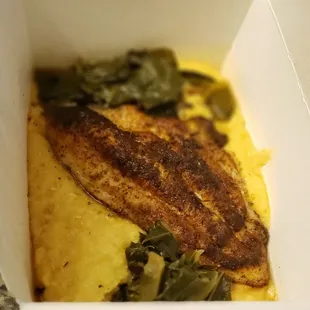 Blackened catfish over yellow grits and collards