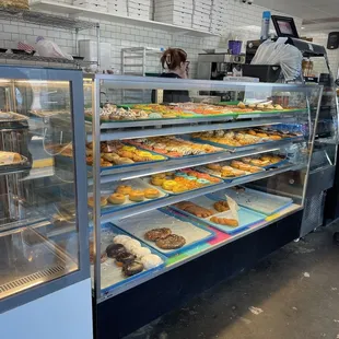 a display case with a variety of doughnuts