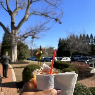 a hand holding a cup of coffee