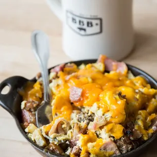 a bowl of breakfast food and a mug of coffee