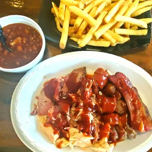 shows a plate of bbq's, french fries, and