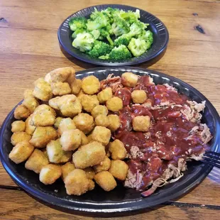 shows a plate of meat, tater tots, brocco