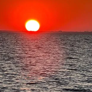 the sun setting over the ocean