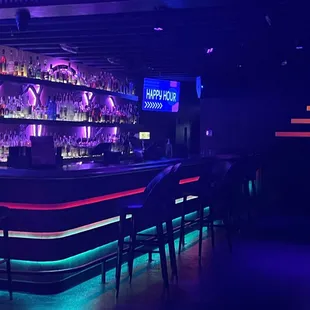 bar with neon lights and bar stools