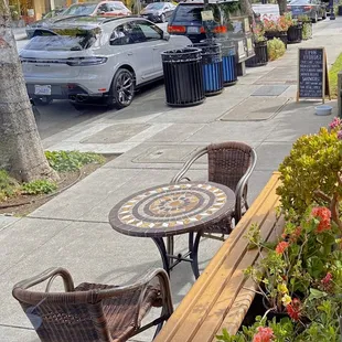 tables and chairs on the sidewalk