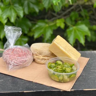 a sandwich, pickles, and cheese